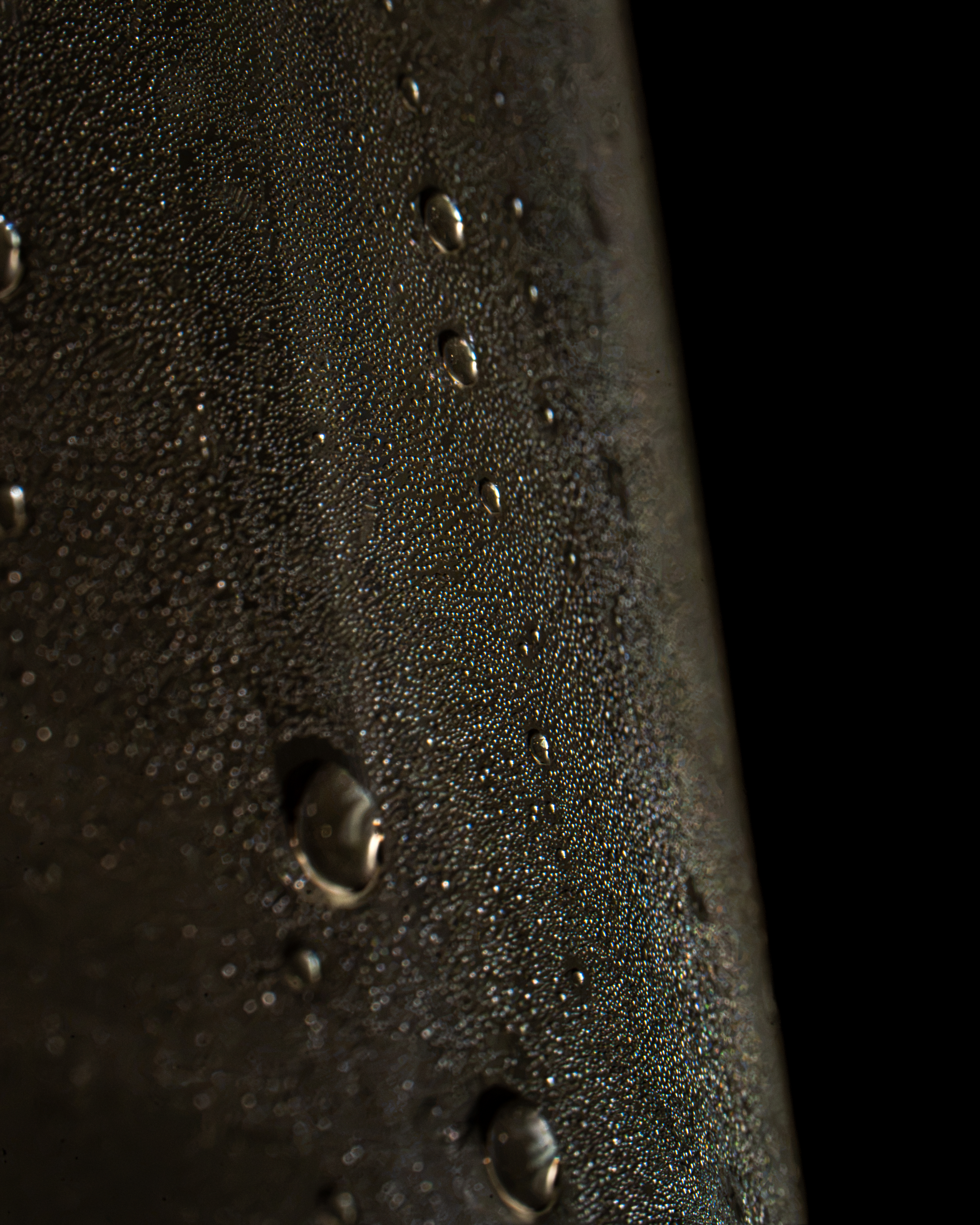 Close up water droplets condensation on dark surface